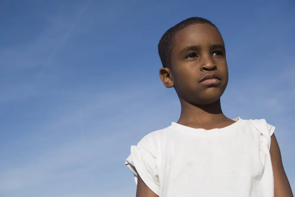 A young child looking forward hopefully