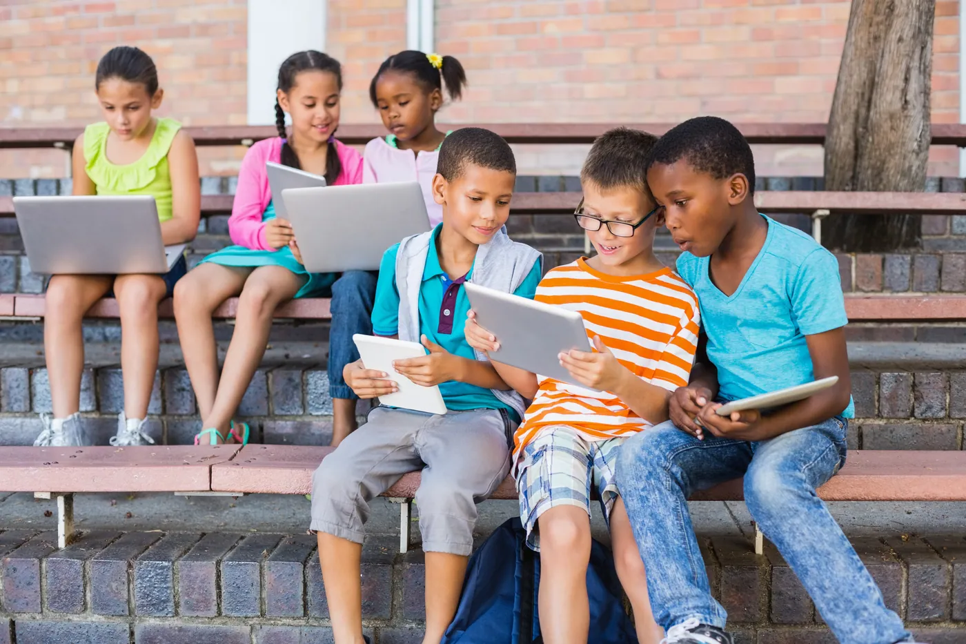Children learning together with tablets